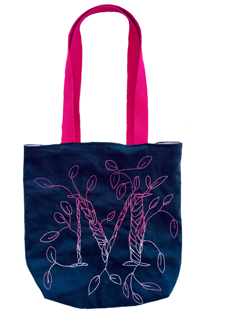 Tote bag with embroidery. The letter M of my name is embroidered with leaves. The colours are bold