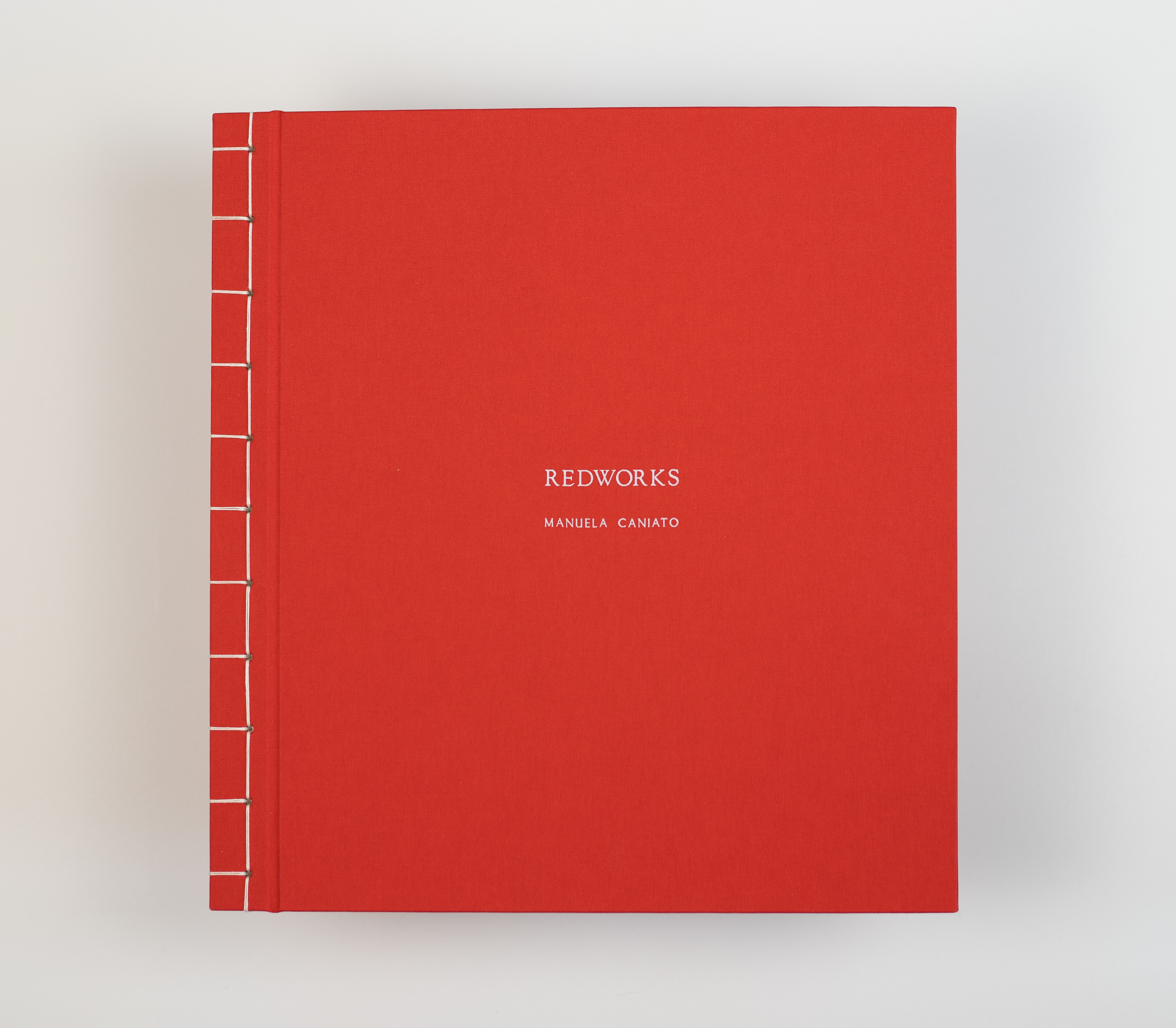 This handmade book showcases delicate red thread artistry, weaving together the simplicity and beauty of daily experiences