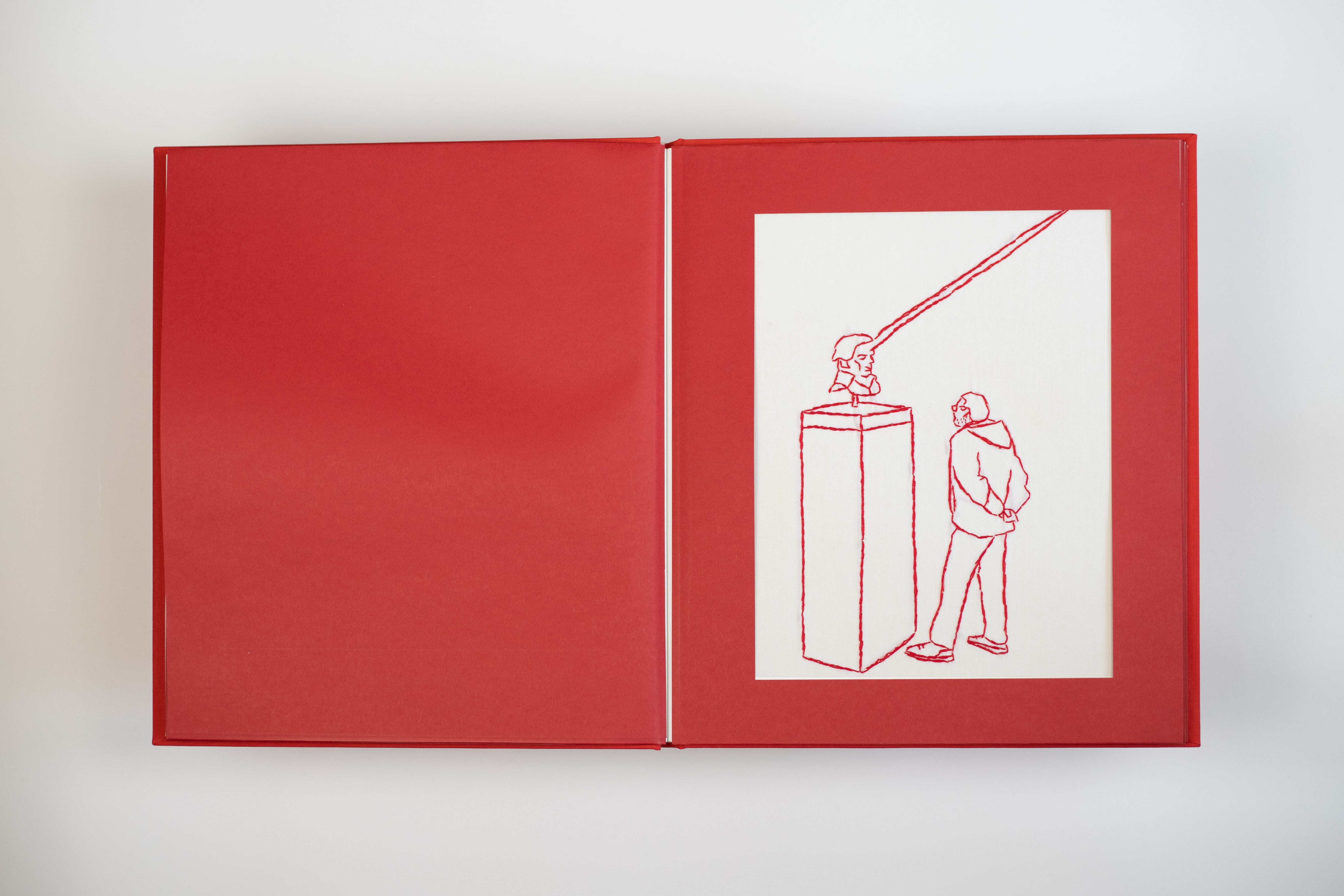 This handmade book showcases delicate red thread artistry, weaving together the simplicity and beauty of daily experiences