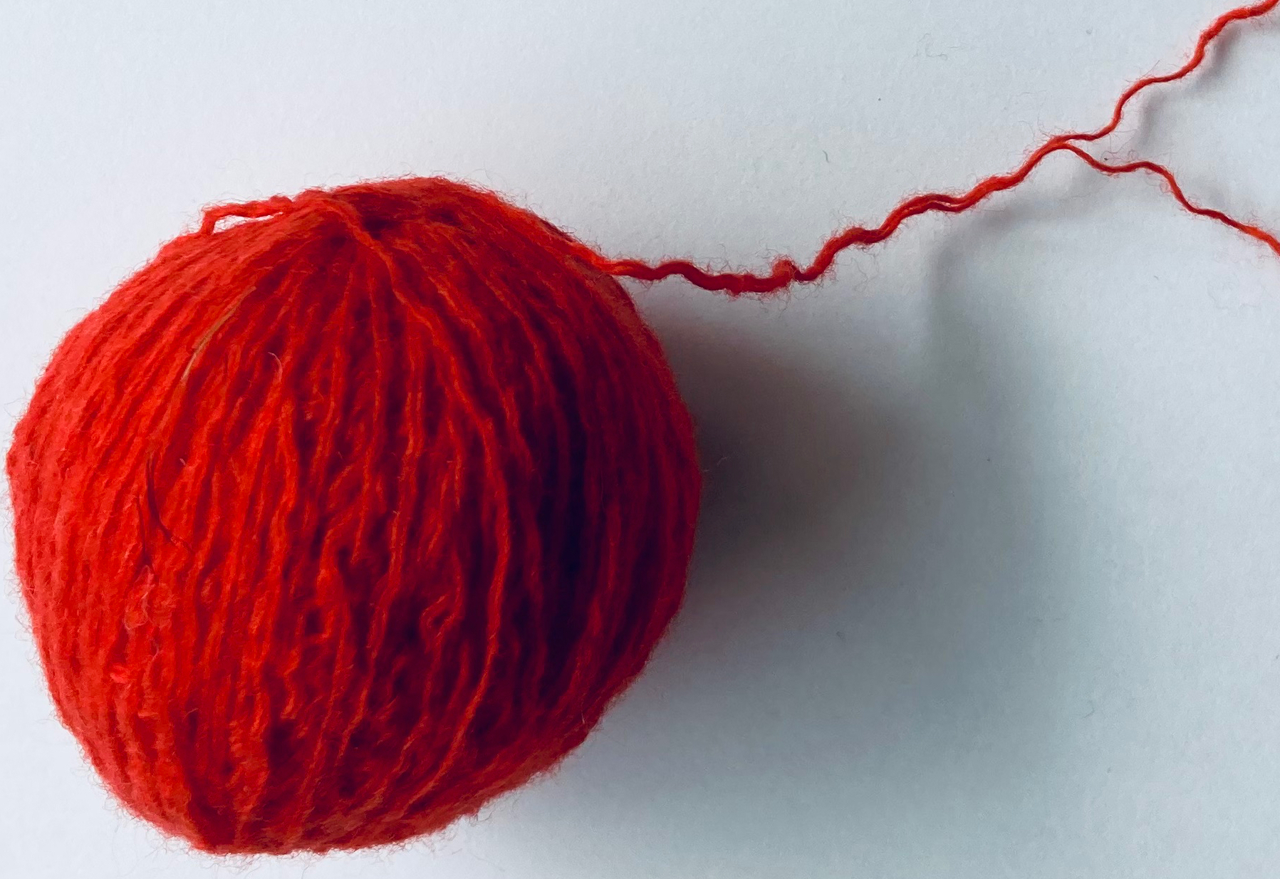 ball of red cashmere with two plies
